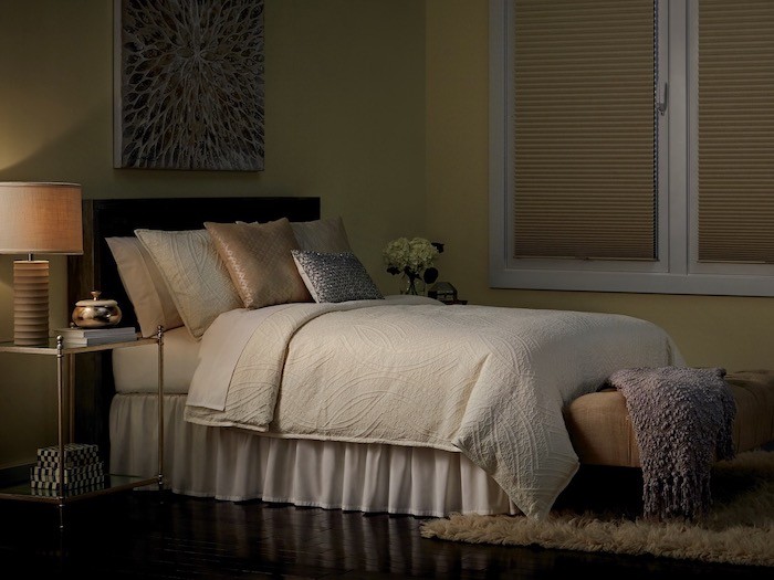 A bedroom with nightstands on both side of the bed.